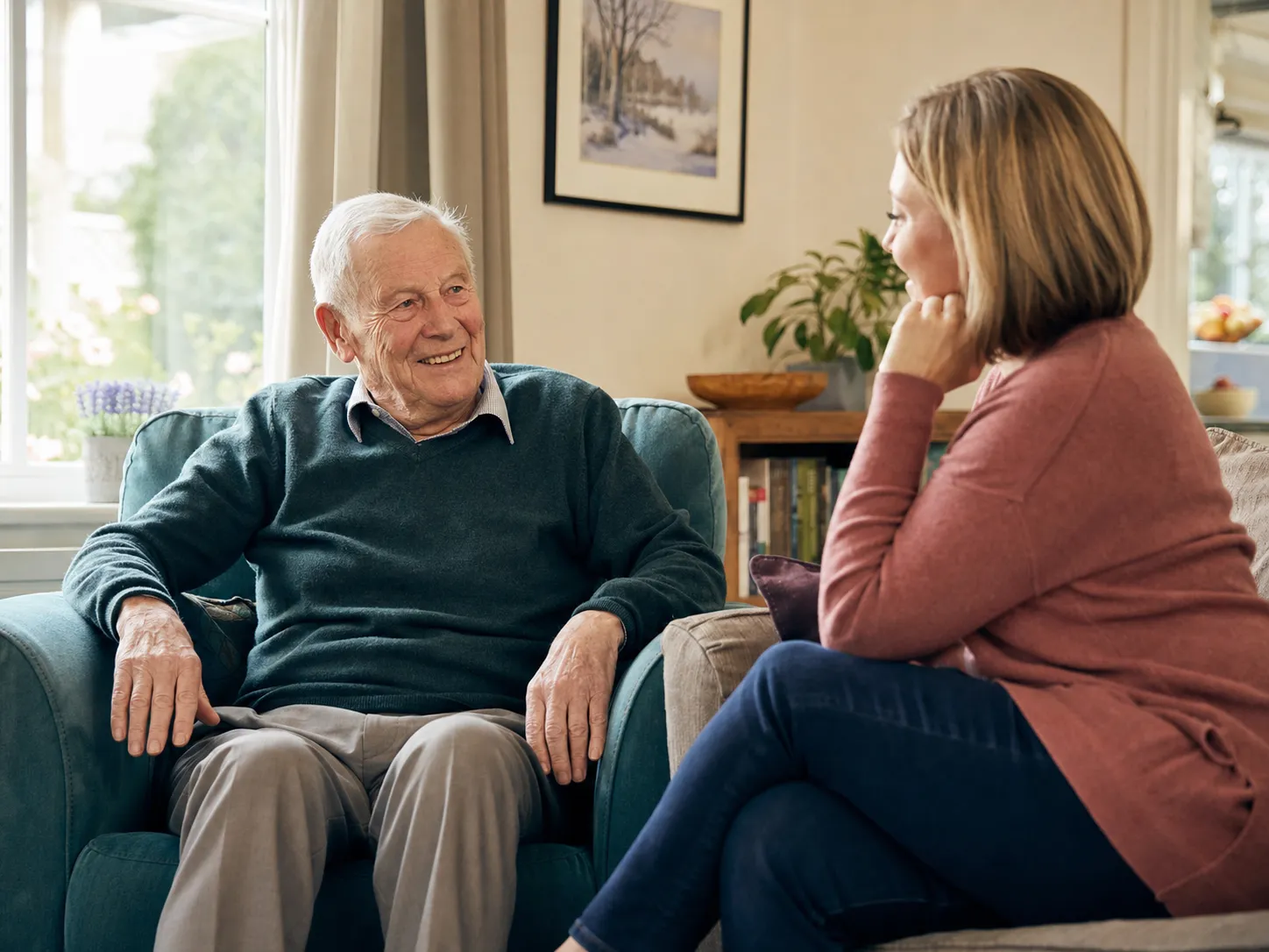 Older man talking comfortably with a family member at home