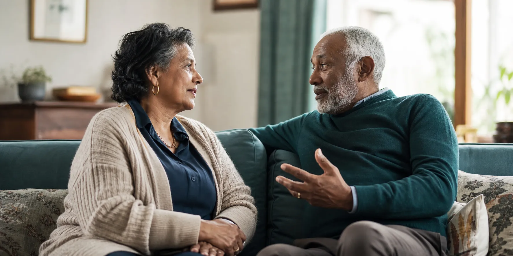 Two older adults sharing a story in relaxed conversation